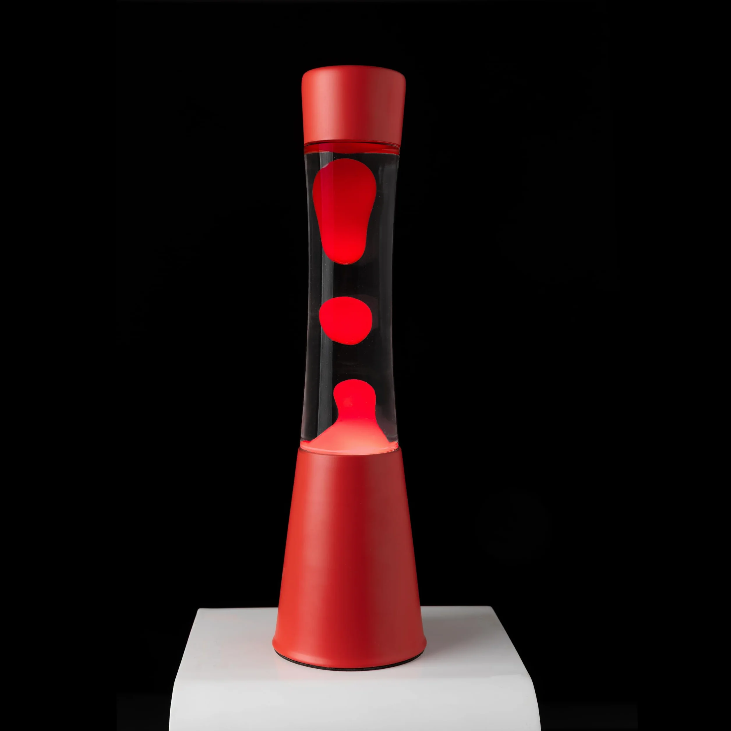 Fisura - Lámpara de lava roja. Base y lava roja con líquido transparente. Lámpara efecto relajante. Con bombilla de repuesto. 11 cm x 11cm x 39,5 cm.